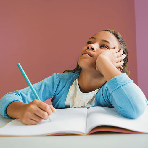 girl trying to do homework but staring up